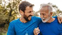 Middle Age Man and Older Man laugh together after exercising